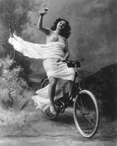 1890 nude on bicycle with glass of wine